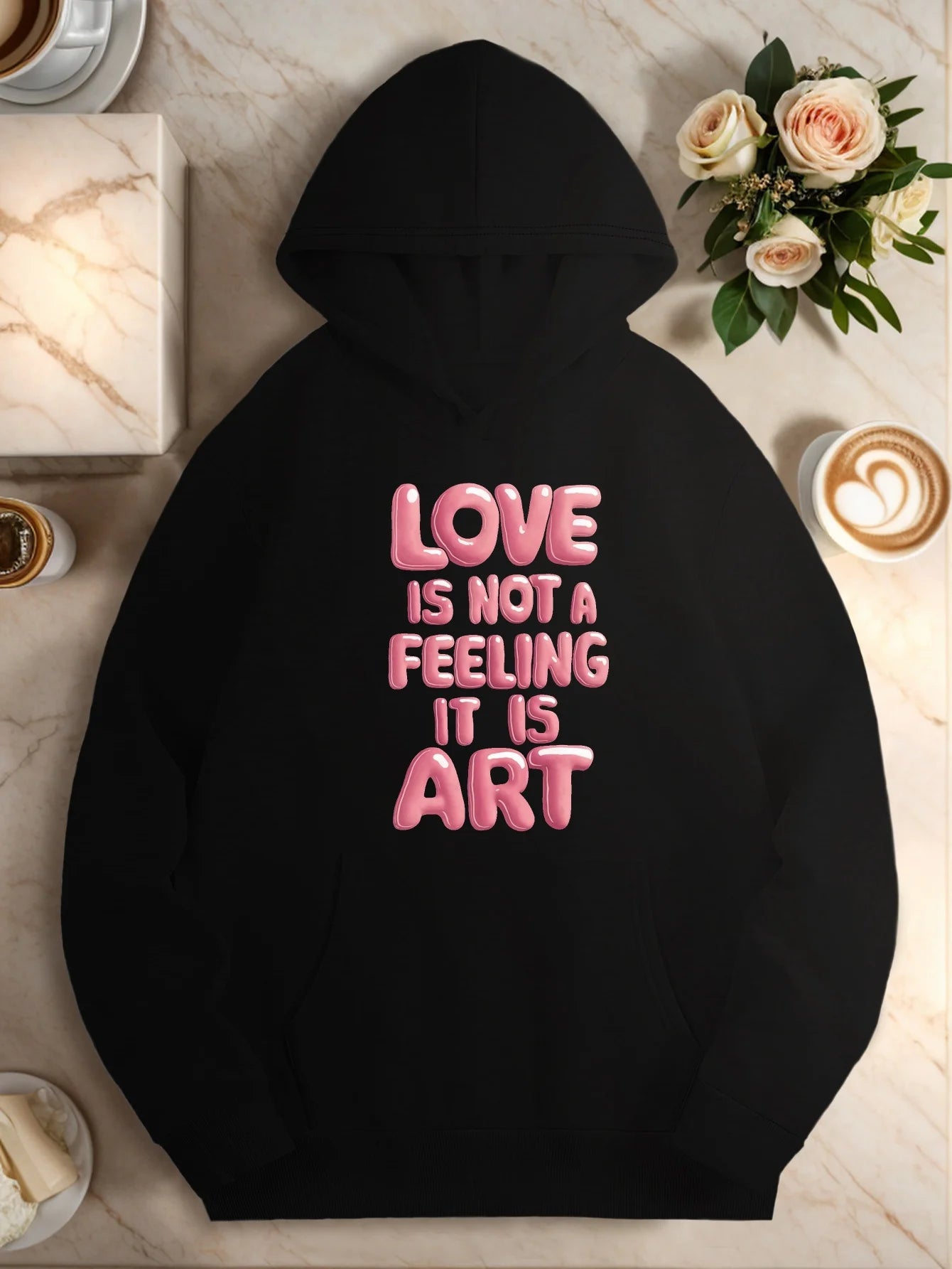 "Love is not a feeling, it's an art." Ladies' hooded sweatshirt - casual black hooded pullover with pink geometric pattern print